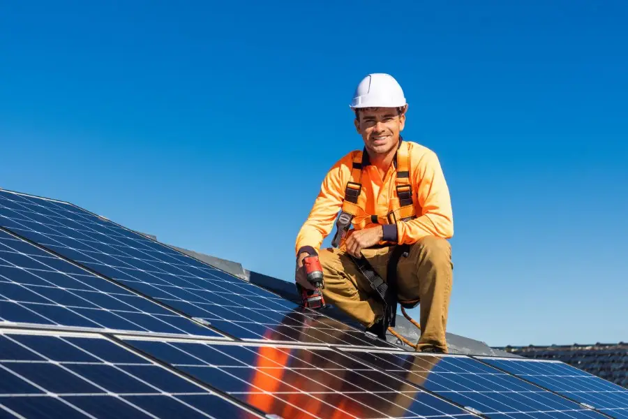 Man fitting solar panels on the roof as a retrofit project using his Flexi orb certification 