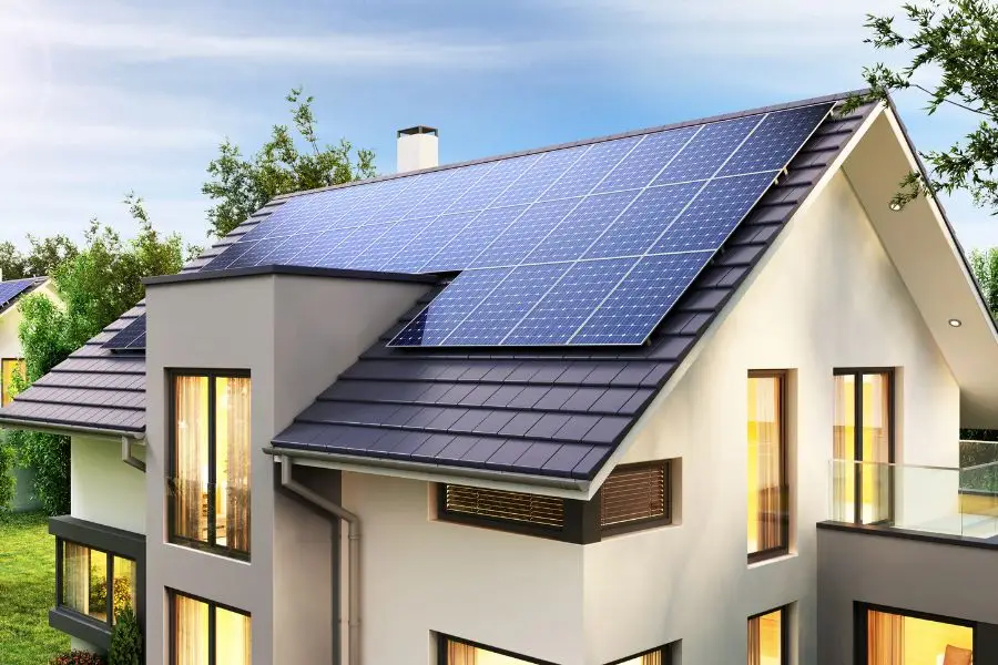 A modern house with a large rooftop solar panel array installed in line with MCS certification standards.