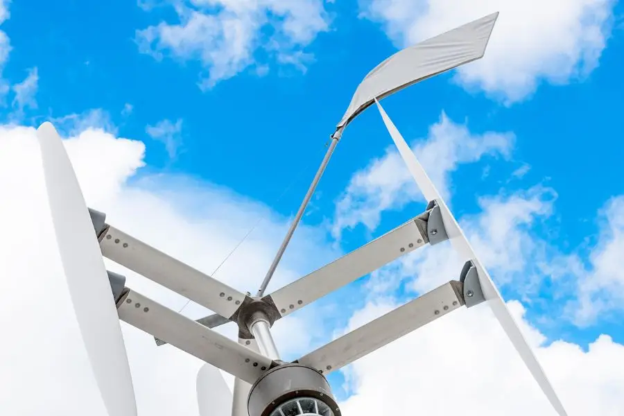 A vertical-axis wind turbine against a blue sky, suitable for small-scale use under MCS certification.